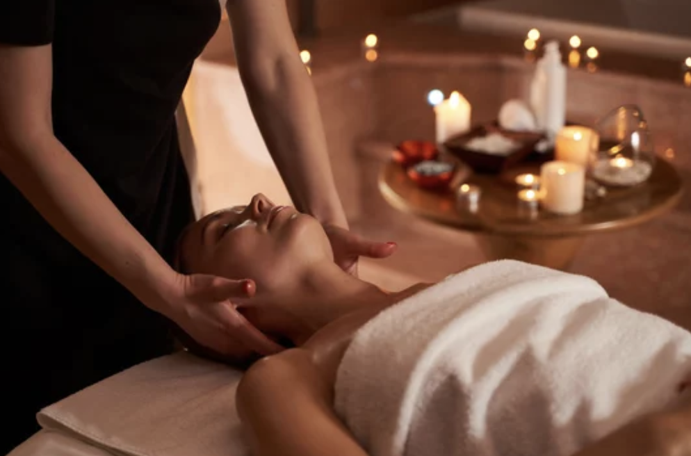 Woman getting a relaxing massage with candles